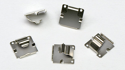 Fourslide-produced battery contacts