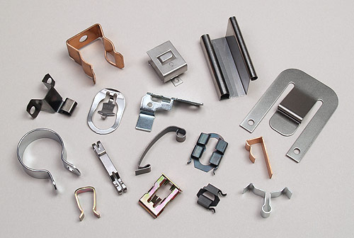 Fourslide clips, clamps, flat springs and contacts